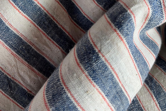 fabrics Material: 100% Kala Cotton
Pattern: Yarn-Dyed Stripes Close-up of striped fabric with blue, red, and white colors.
